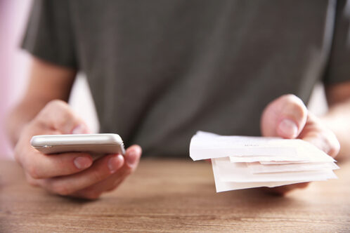 Man making calculations on phone