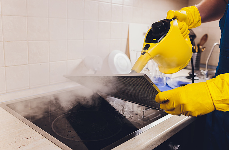 Steam cleaner being used to clean extractor fan