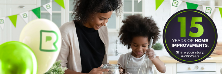 Mother and child cooking with Rated People competition balloons and banner