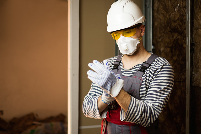 Tradesperson putting gloves on