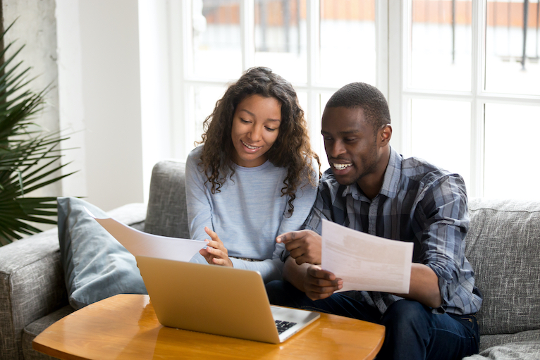 Couple looking at their house insurance policy documents