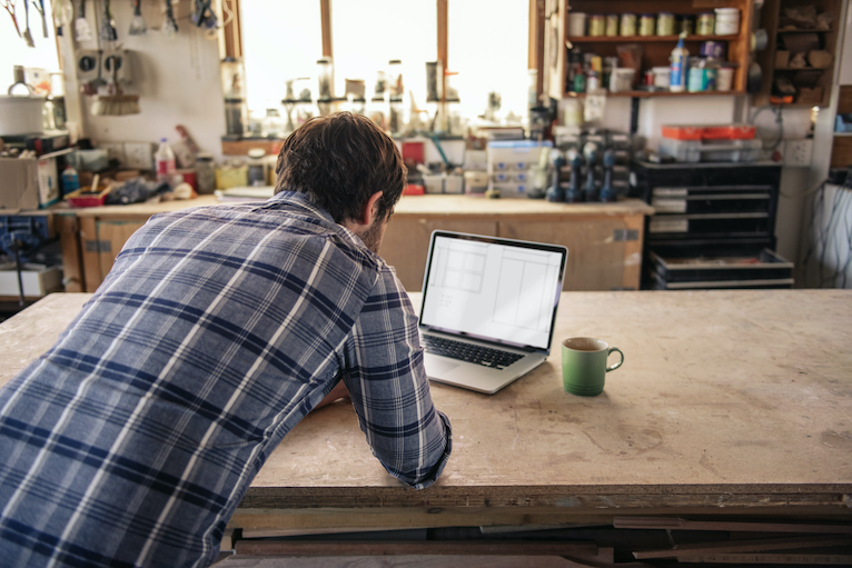 Tradesperson looking at laptop 