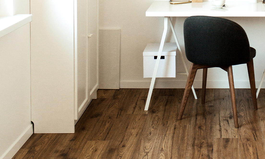 Medium brown wooden floorboards in a home office.