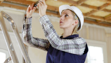 Tradesperson taking photo inside home