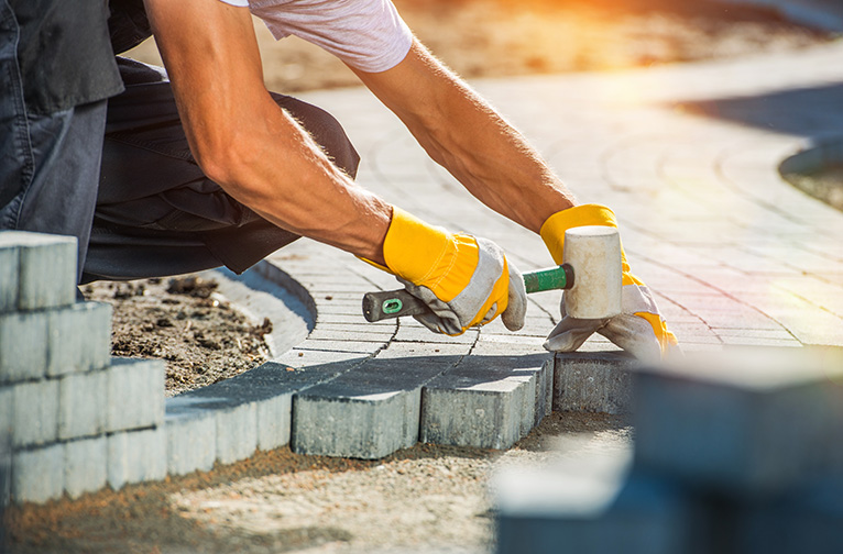 Driveway paver installing paving stones