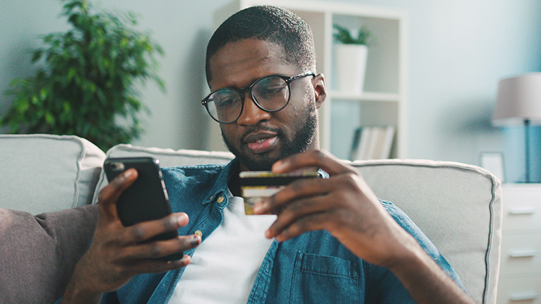 Man holding phone and credit card