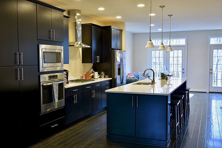 Modern kitchen with dark cabinets and light countertops