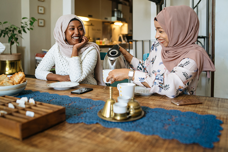 Two people drinking tea at table