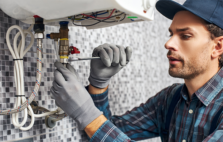 Gas/heating engineer working on electric boiler