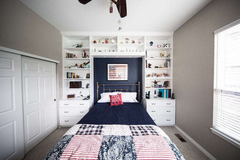 Bedroom with built-in storage around bed