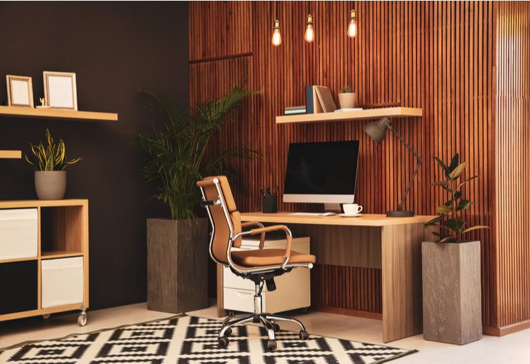 Slimline wall panelling in dark wood on a wall in an orange-themed home office