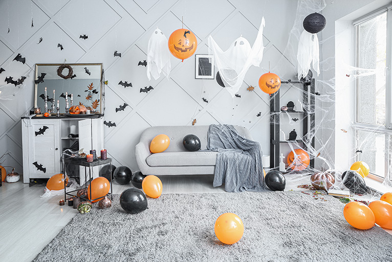 Interior of room decorated with spooky ghosts, bats and cobwebs for a Halloween party.