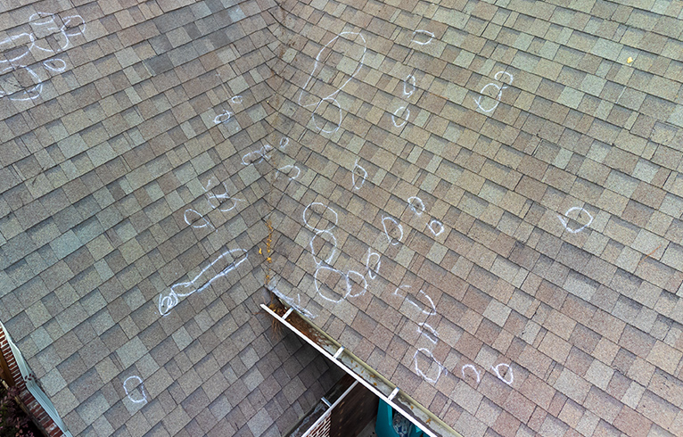 Flat roof with wear and tear damage incurred over time. 