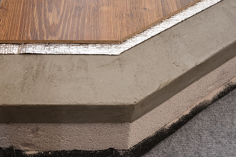 Close-up of floor insulation and sound proofing layers under wooden floor.