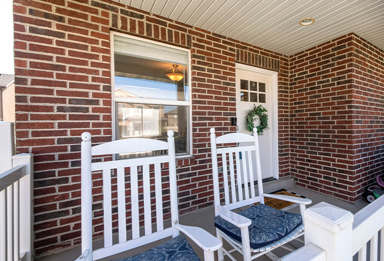 White wooden chairs in front of house