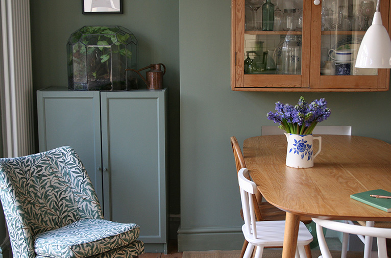 Beautiful interior of a dining room painted moody green