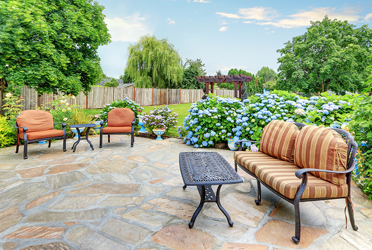 garden with flagstone floor and garden furniture and pergola