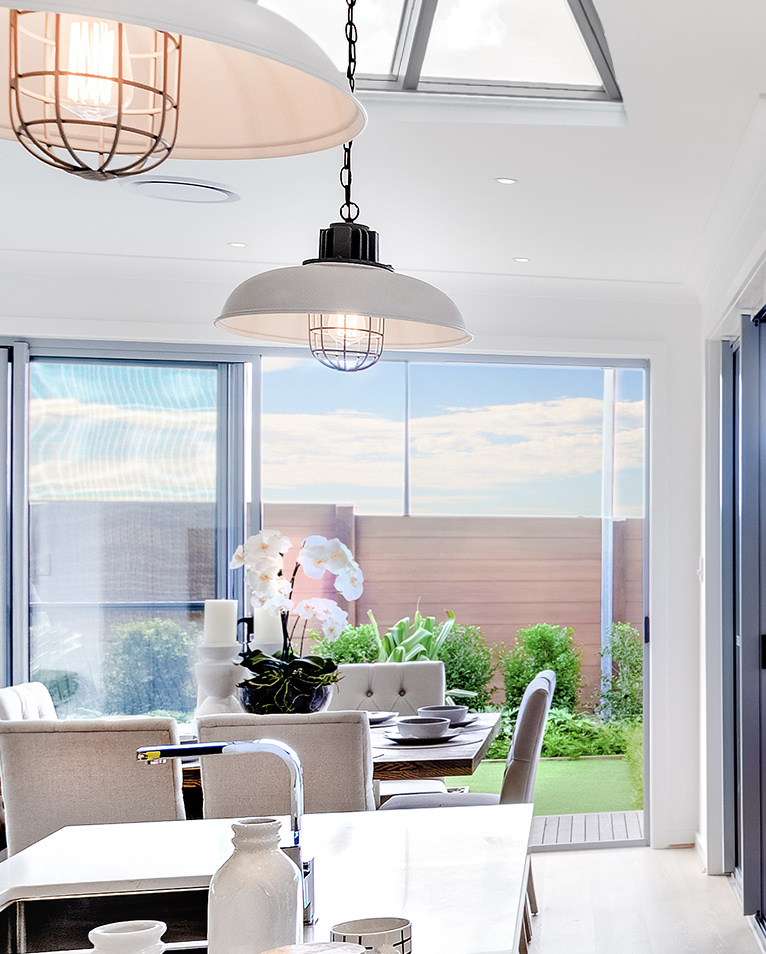 Contemporary hanging lights in modern orangery