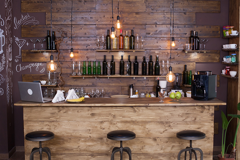 All wooden home bar with wooden wall panelling behind