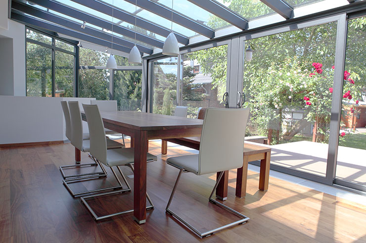 Image of a modern orangery with dining table and chairs