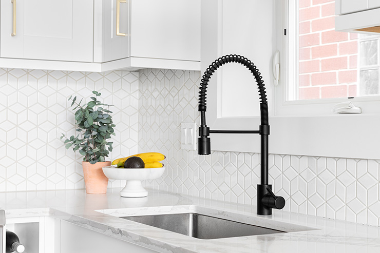 Picture of a kitchen with a geometric design and white cabinets