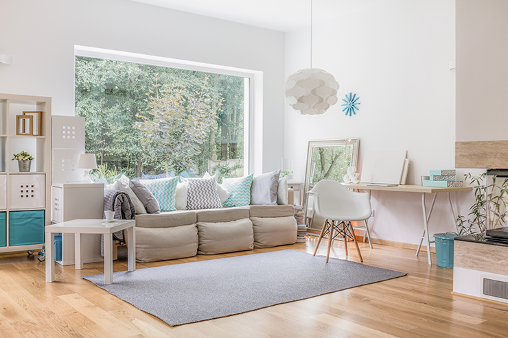 Picture of a living room with a large window and wooden floors