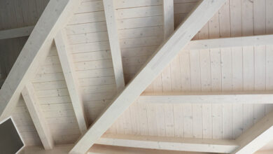 Picture of a wooden roof with wood beams painted white