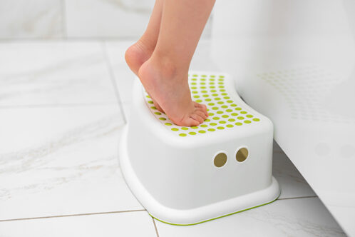 Picture of a child's feet on a bathroom stool