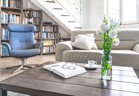 Picture of a living room with a library under the stairs