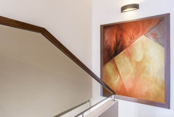 Picture of a piece of art hanging from wall near staircase