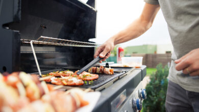 Picture of a man cooking food on an outdoor BBQ