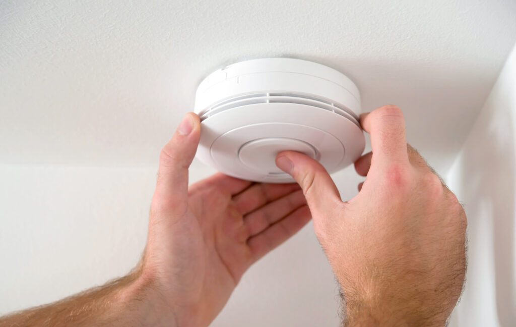 Picture of a carbon monoxide detector being installed 