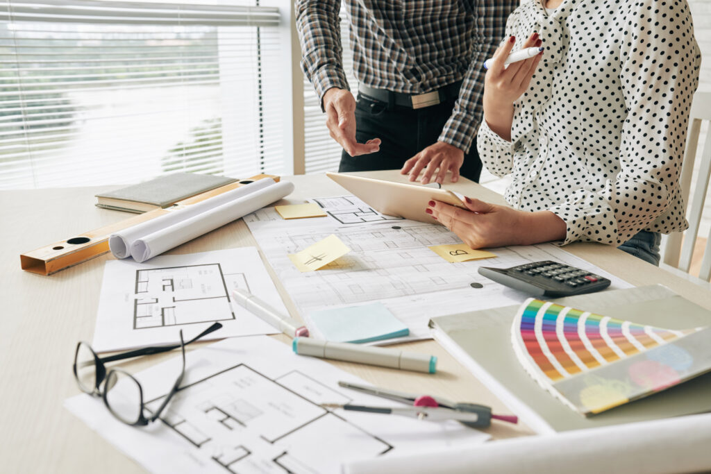 Picture of two people looking at house plans and discussing interior design